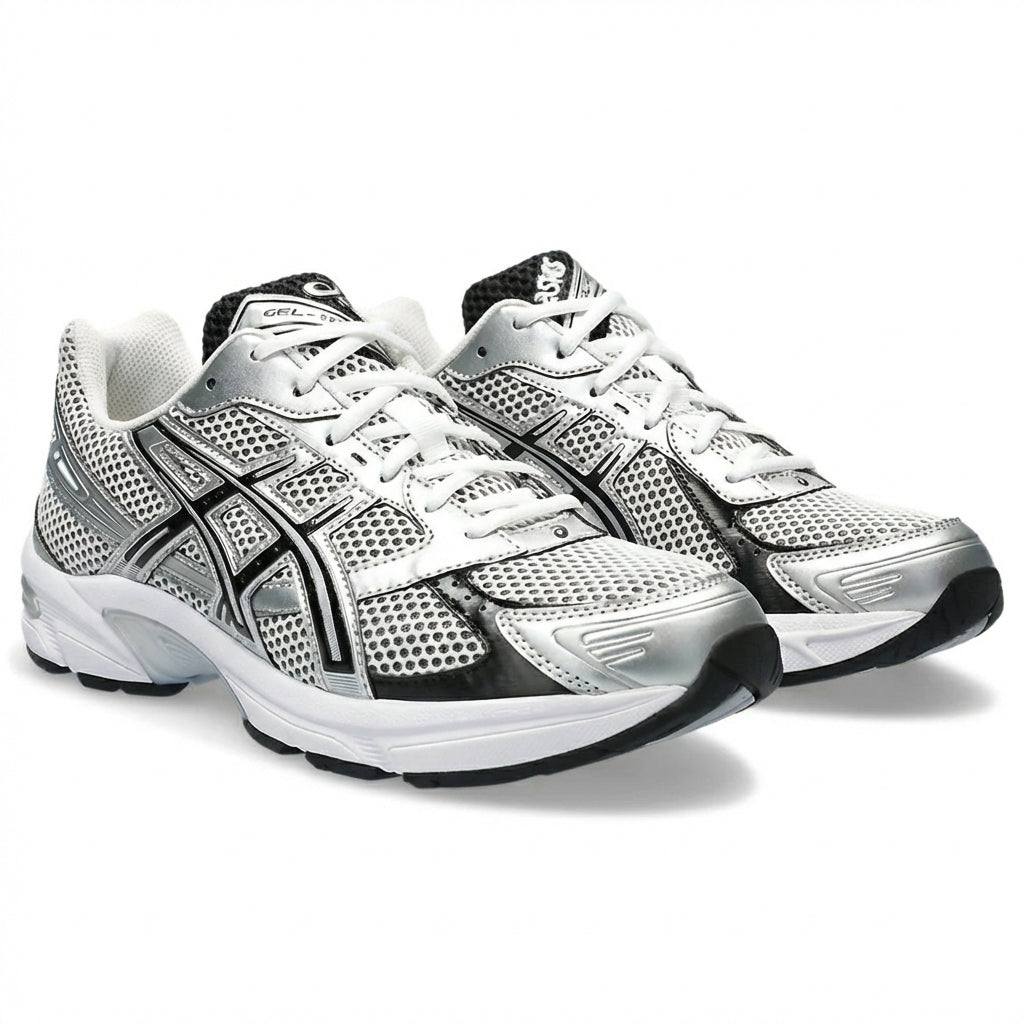 ASICS GEL-1130 White Black Silver 1201A933-100 lateral side profile showing the white mesh upper with honeycomb pattern, bold black tiger stripes, metallic silver synthetic overlays across the midfoot and heel, white midsole, and black outsole
