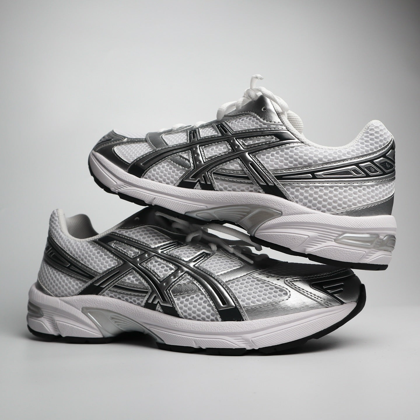 ASICS GEL-1130 White Silver pair showing lateral and medial sides with GEL midsole