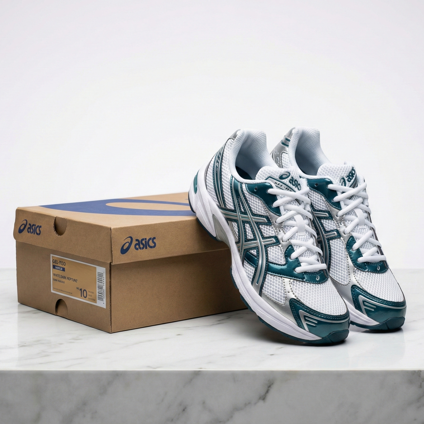 ASICS Gel-1130 White Dark Neptune pair displayed with ASICS shoe box on marble surface showing White Dark Neptune colourway label and front three-quarter angle