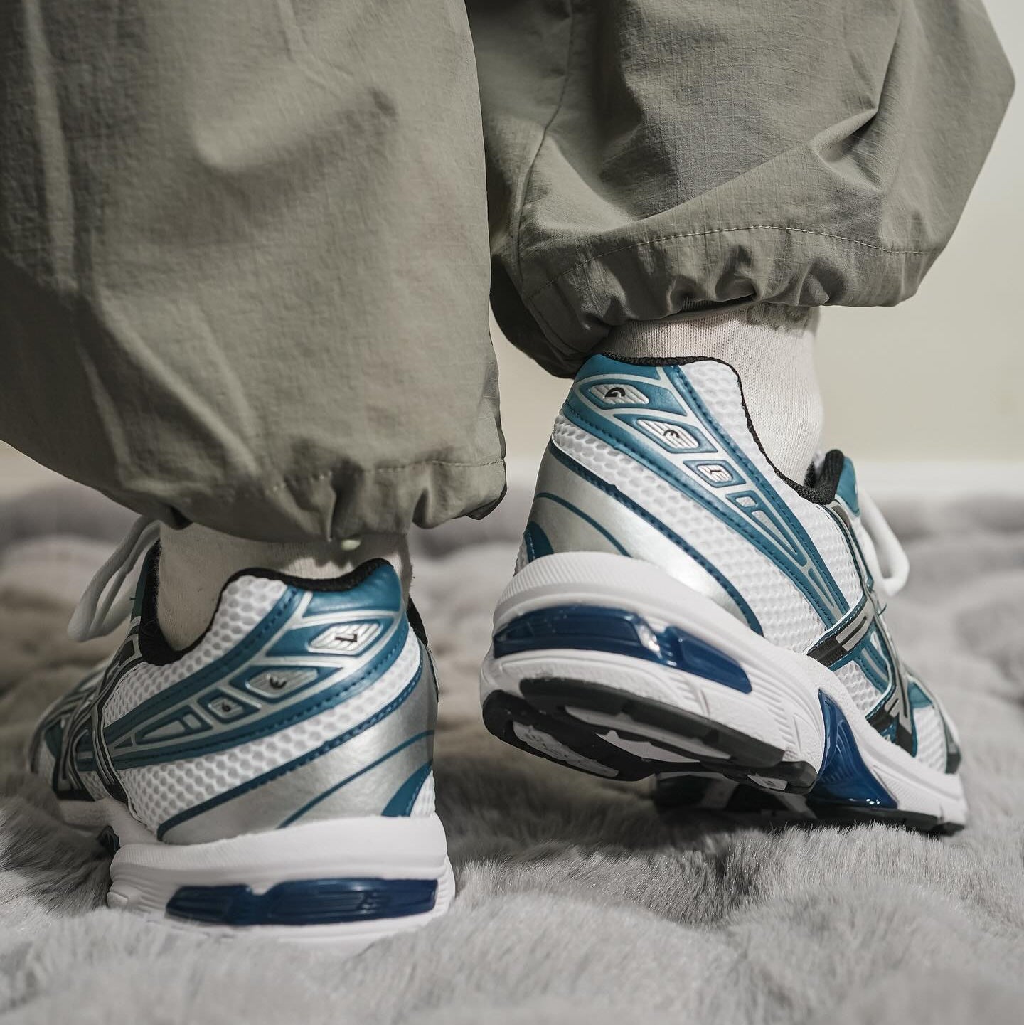 ASICS Gel-1130 White Restful Teal on feet rear view styled with grey cargo trousers