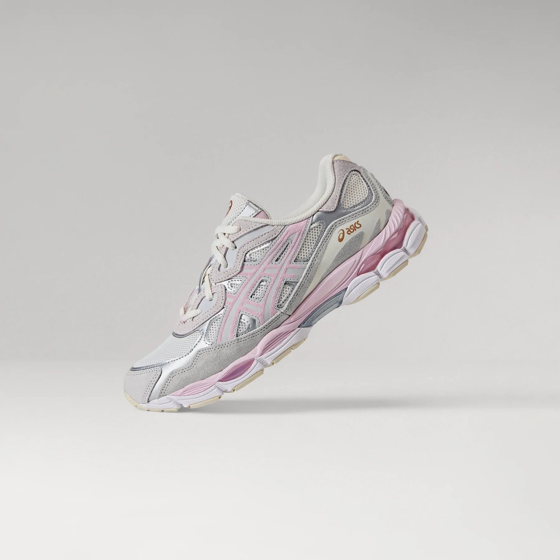 ASICS Gel-NYC Barely Rose single shoe floating angle on grey studio background showing medial side with pink tiger stripes, silver panels, and chunky pink midsole
