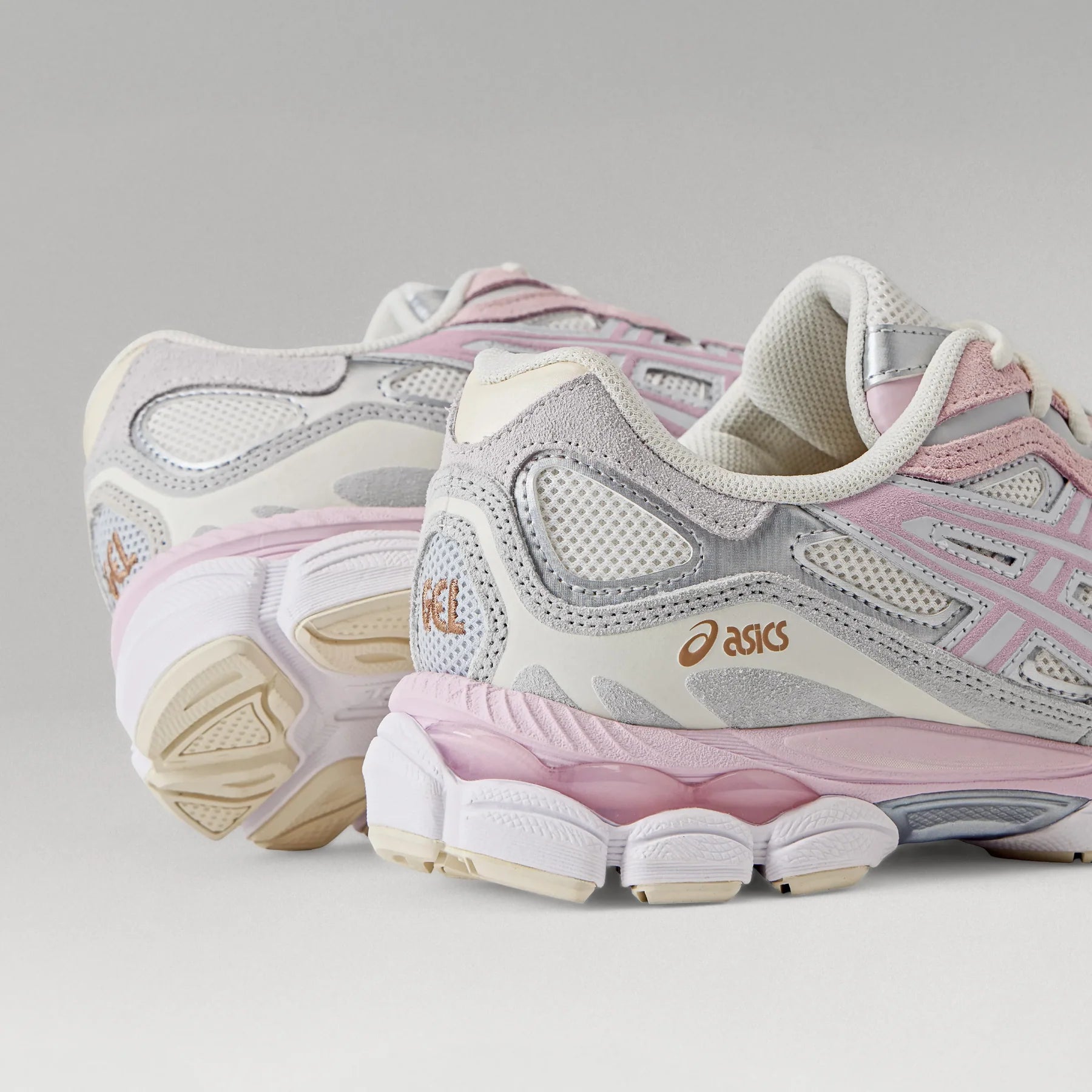 ASICS Gel-NYC Barely Rose close-up of heel area showing gold ASICS branding, grey suede overlays, silver accents, and translucent pink GEL cushioning midsole