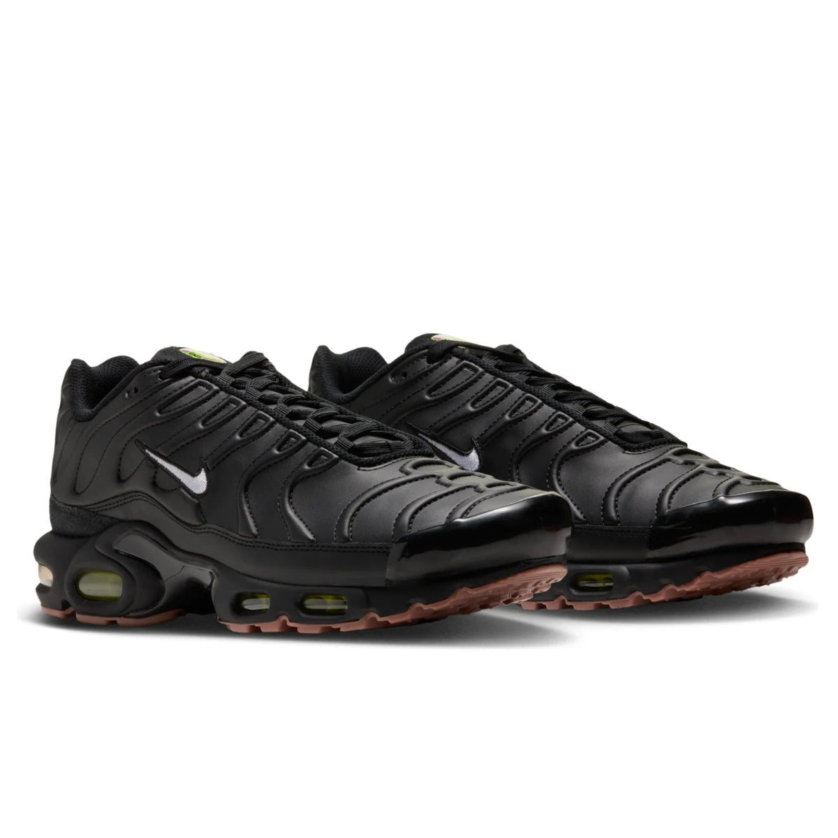 A pair of Nike Air Max Plus Premier Black Volt trainers featuring a black synthetic leather upper, stitched wave detailing, white Swooshes and visible Tuned Air cushioning on a clean white background.