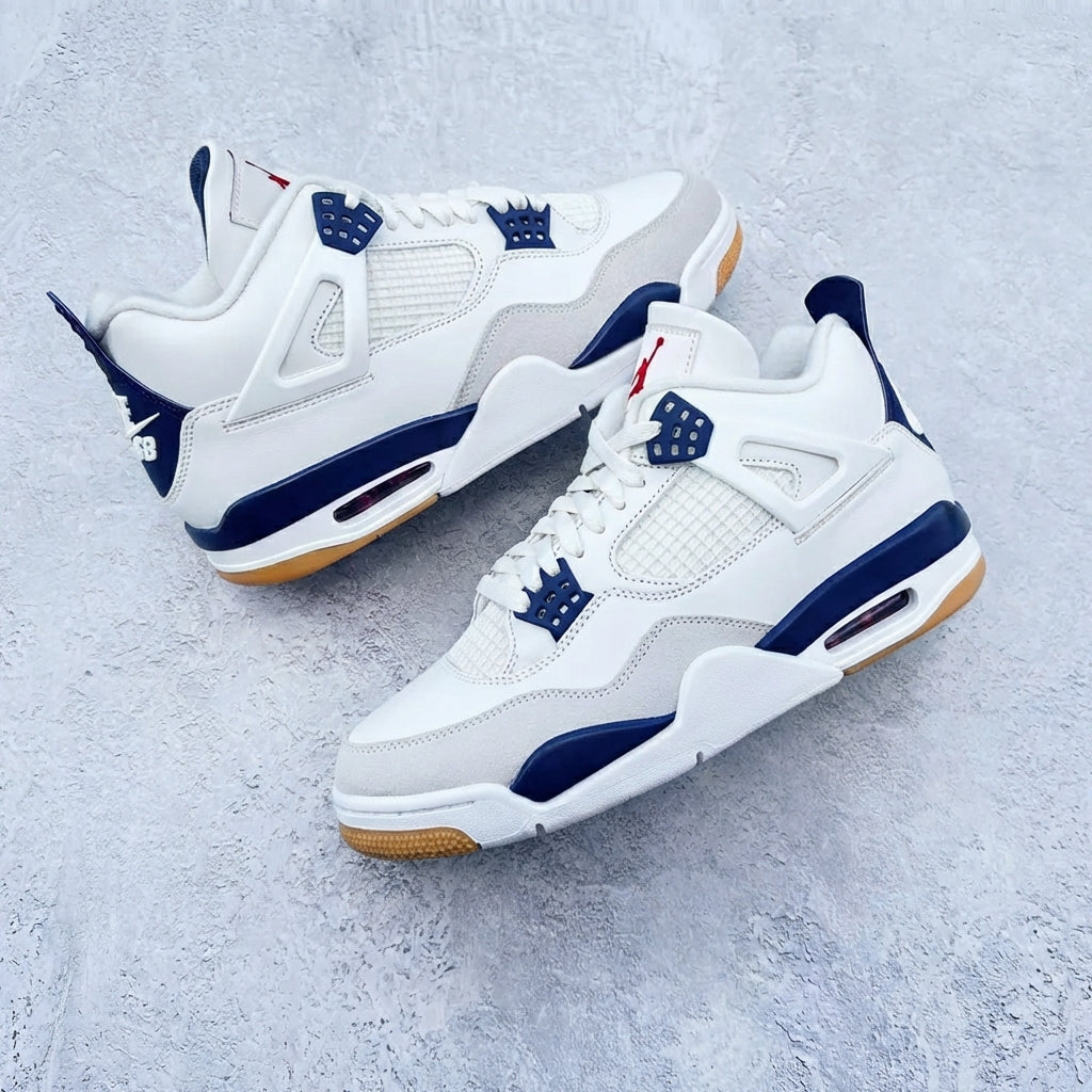 Jordan 4 Retro Nike SB Navy pair flat lay on concrete showing white leather upper navy accents and gum rubber outsole