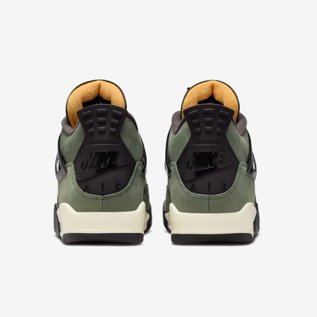 Jordan 4 Retro x UNDEFEATED - rear heel view of both shoes showing black Nike Air branding on heel, olive nubuck upper, orange inner lining, black heel tab and sail midsole