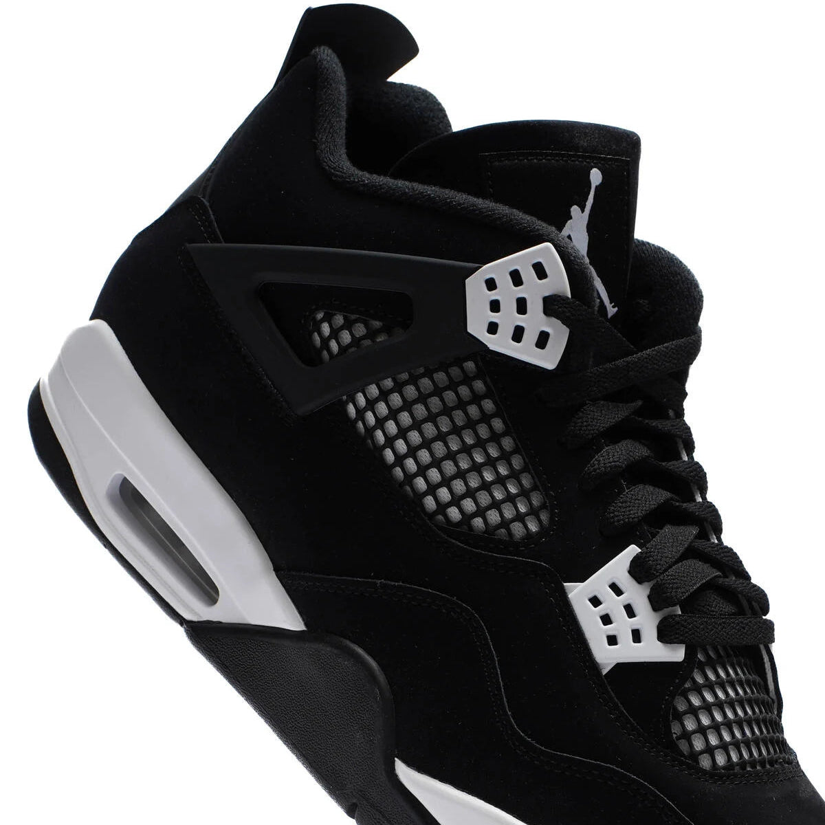 Jordan 4 Retro White Thunder lateral close-up showing black canvas upper, dark TPU support wing, white lace cage eyelets, black mesh netting, and white midsole
