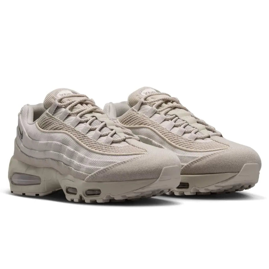 A pair of Nike Air Max 95 Canvas Cream trainers featuring layered cream and earthy neutral uppers with visible Max Air cushioning on a clean white background.