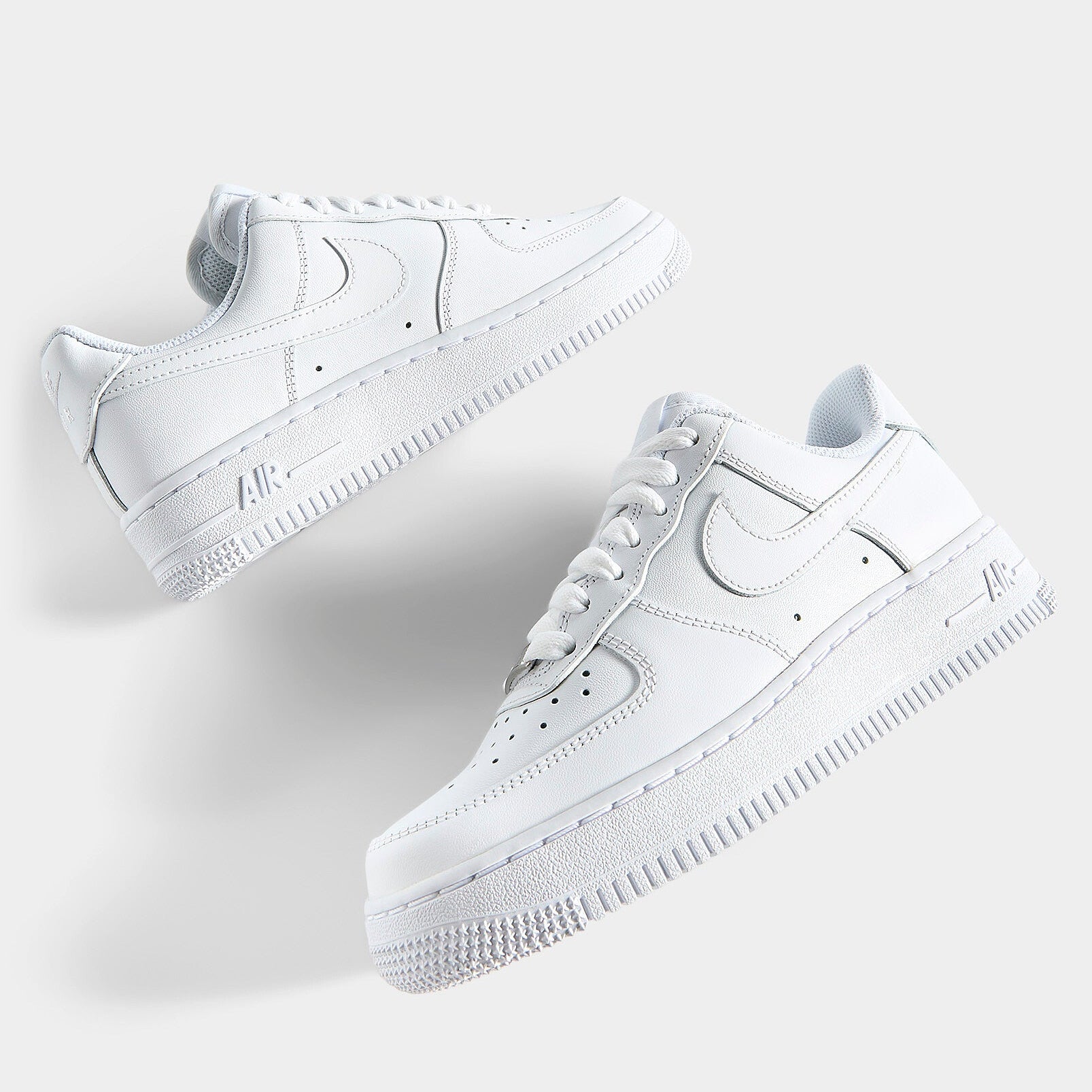Nike Air Force 1 '07 Triple White pair top-down flat lay showing Air branding on midsole