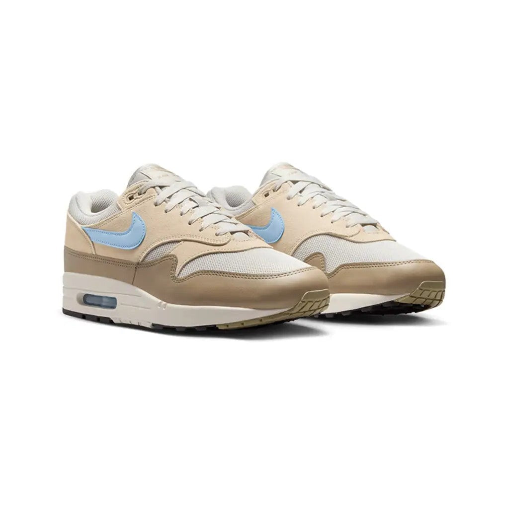 Nike Air Max 1 Light Bone Psychic Blue pair front three-quarter view on white background showing tan suede overlays, blue Swoosh, mesh toe box, and khaki mudguard