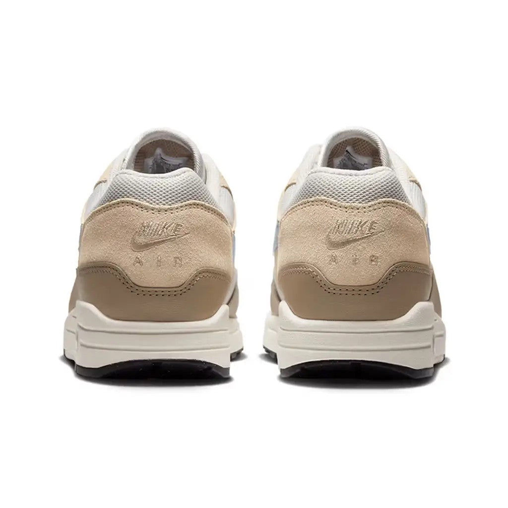 Nike Air Max 1 Light Bone Psychic Blue rear view of pair showing embossed Nike Air branding on suede heel tab, khaki leather mudguard, and sail midsole