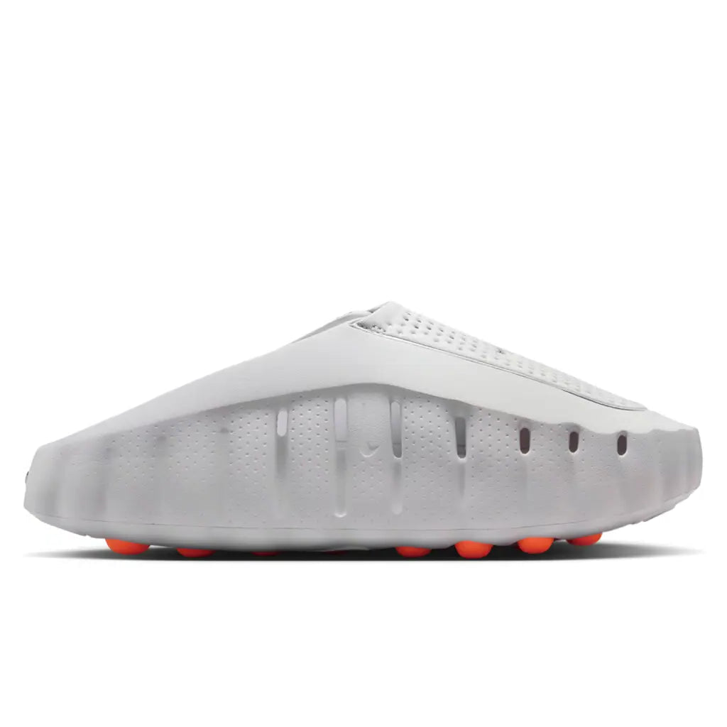 Nike Mind 001 Light Smoke Grey medial side profile showing foam midsole and orange sensory nodes on outsole