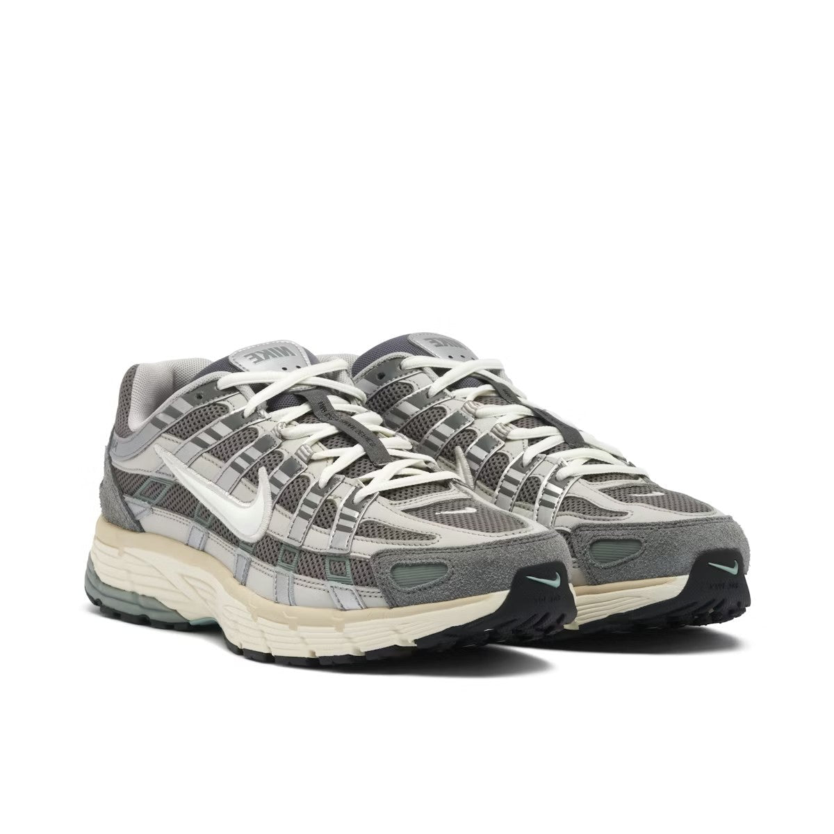 Nike P-6000 Flat Pewter pair front three-quarter view on white background showing grey mesh, silver straps, white Swoosh, aqua green toe accents, and Nike tongue branding