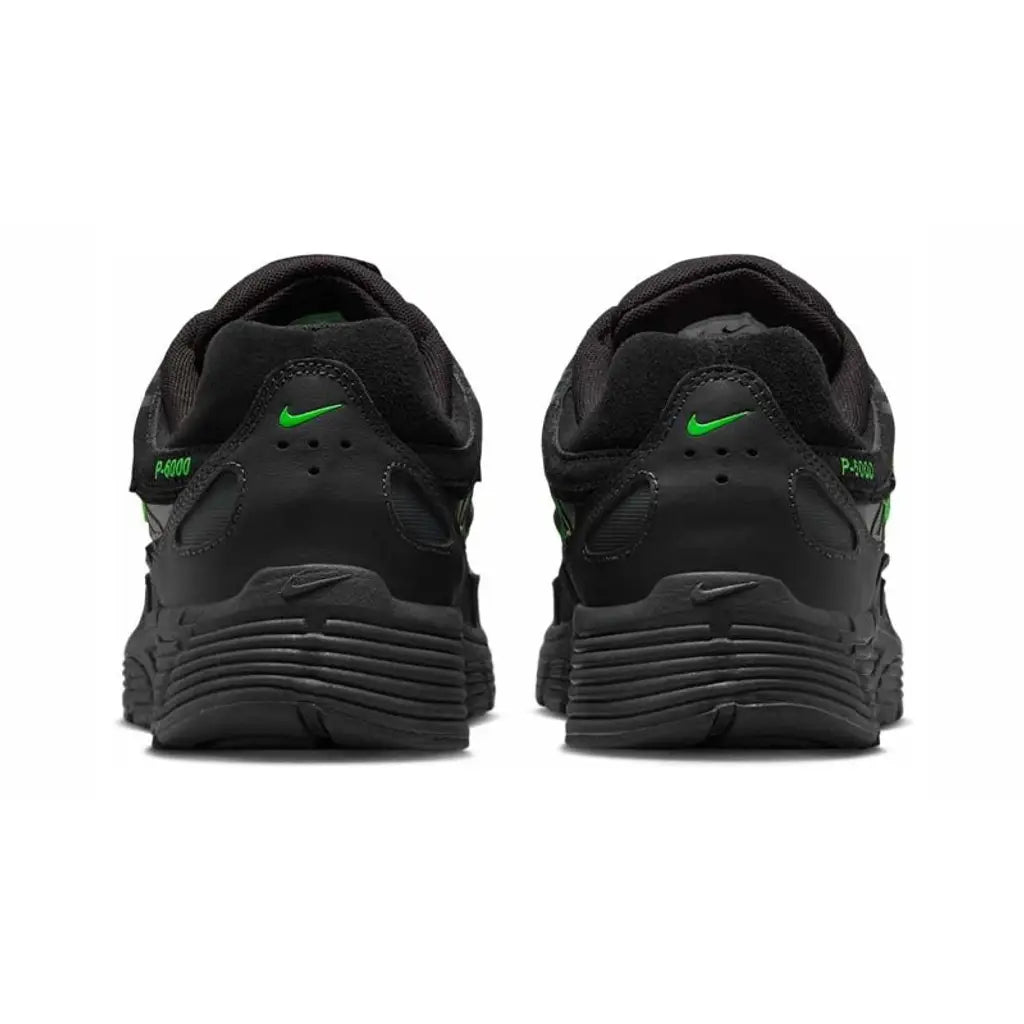 Nike P-6000 PRM Black Green Strike rear heel view of both shoes showing the black padded collar, small green Nike Swoosh on each heel tab, green P-6000 branding on the outer heel, and black ribbed midsole
