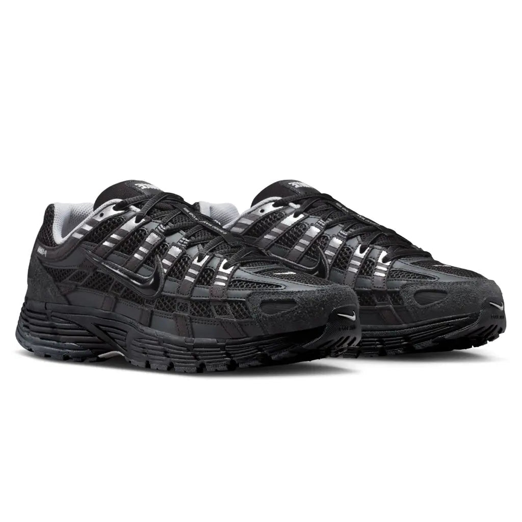 Nike P-6000 Suede Anthracite Metallic Silver pair front three-quarter view on white background showing black mesh, metallic silver straps, and anthracite suede mudguard