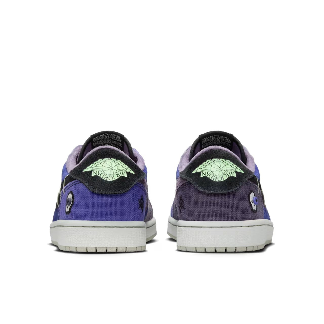 Zion Williamson x Air Jordan 1 Low OG Voodoo Alternate - rear heel view of both shoes showing mismatched purple and blue canvas, Vapor Green glow-in-the-dark Air Jordan Wings logo, skull embroidery and grey midsole