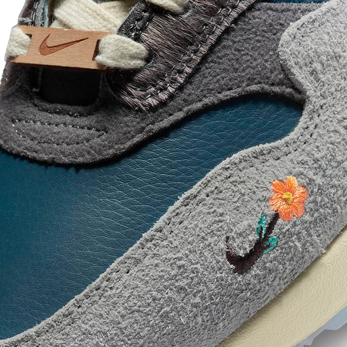Close-up of the Kasina x Nike Air Max 1 Wong-Ang Grey featuring Wong-Ang duck embroidery, floral detailing and collaborative Kasina branding.