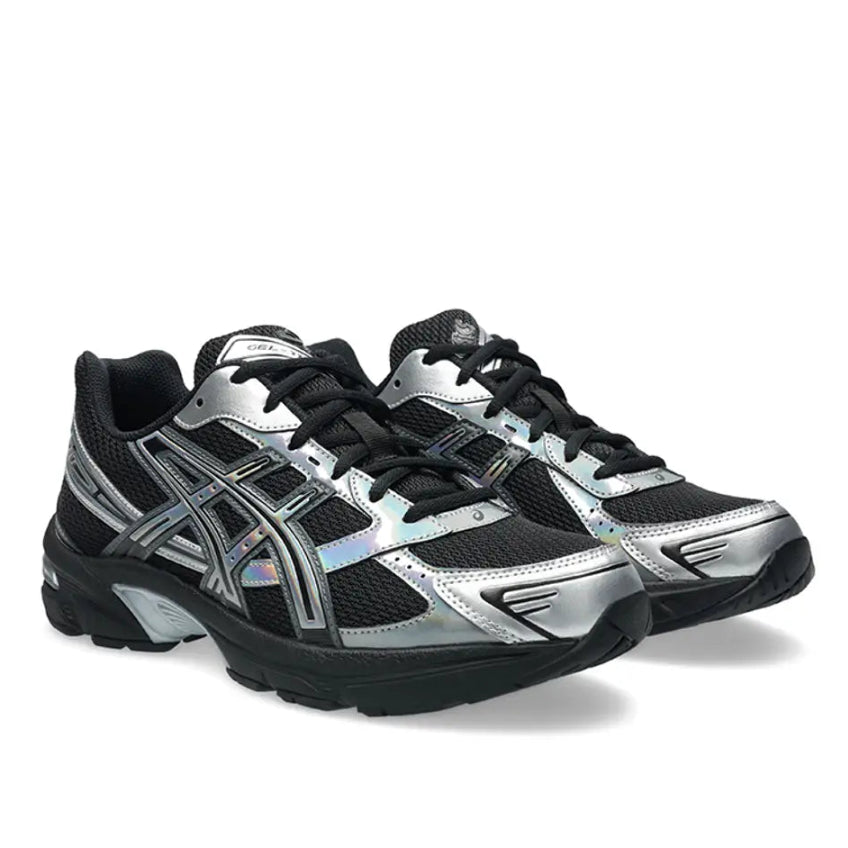 A pair of ASICS GEL-1130 Holiday Pack Black trainers featuring a black mesh upper, iridescent silver overlays, signature ASICS stripes and a black cushioned GEL sole on a clean white background.