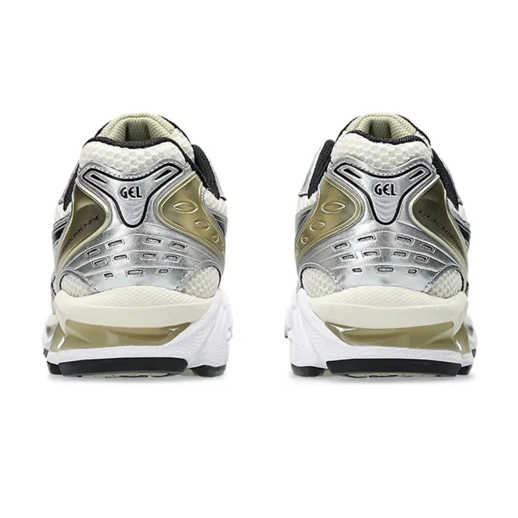 A rear view of the ASICS GEL-KAYANO 14 Birch Silver trainers, showing the structured heel, cream and silver detailing and technical cushioned sole on a clean white background.