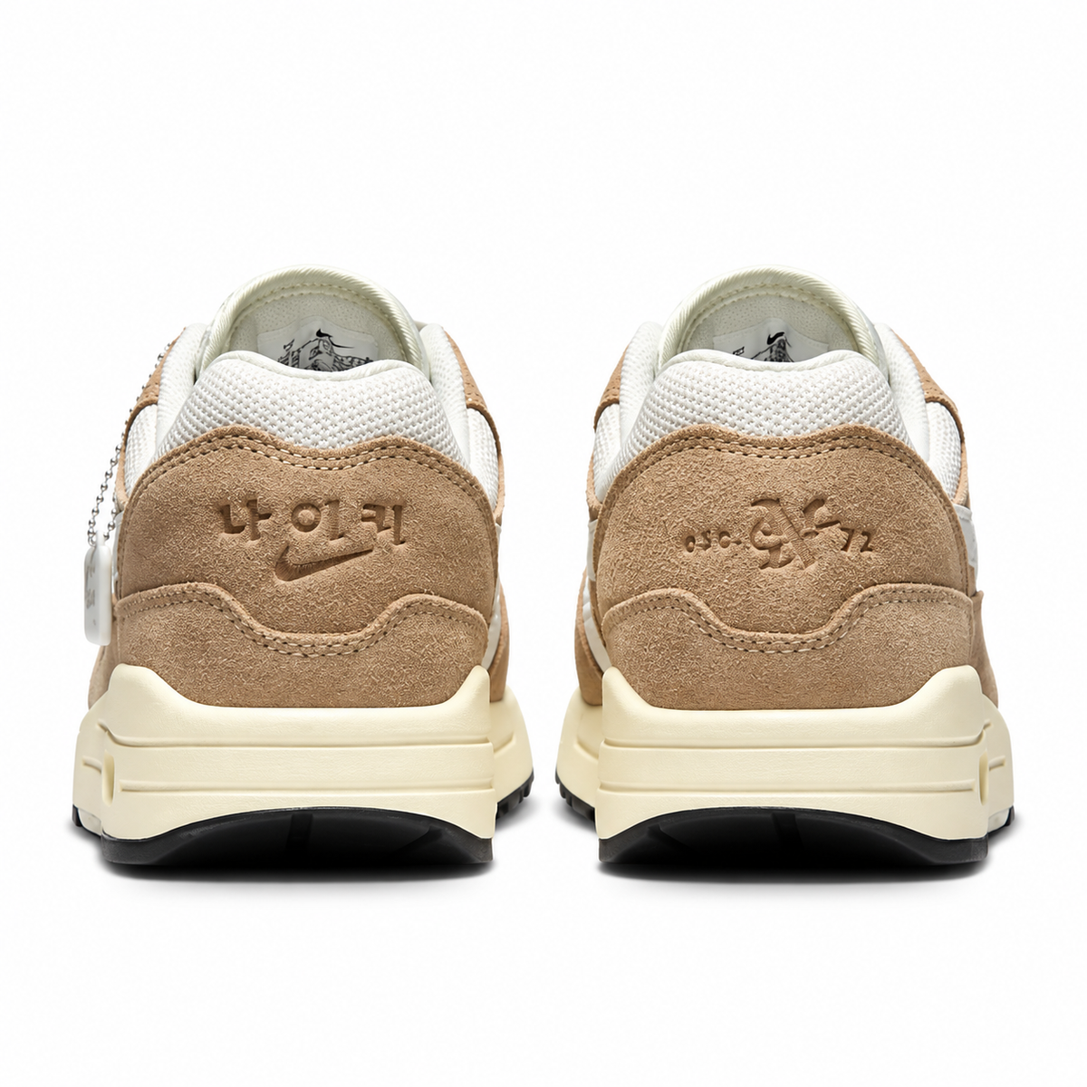 A rear view of the Nike Air Max 1 Hangul Day trainers, showing the special Hangul branding, “Est. 72” detailing and light brown suede heel panels.