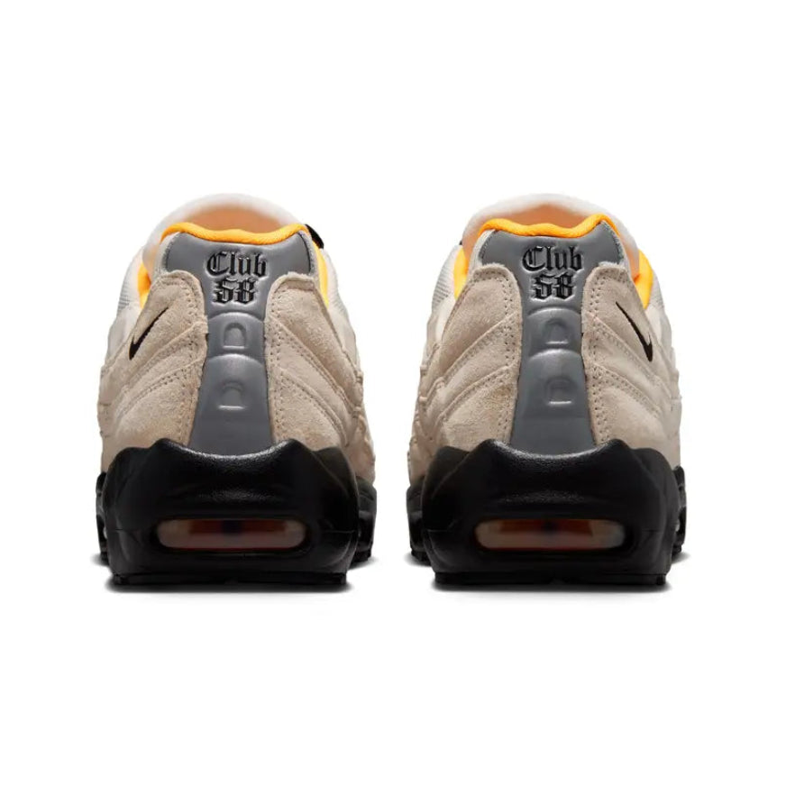 A rear view of the Nike SB Air Max 95 World Cup Pack Sail trainers, showing the SB Air branding, neutral layered construction and bright orange accents.