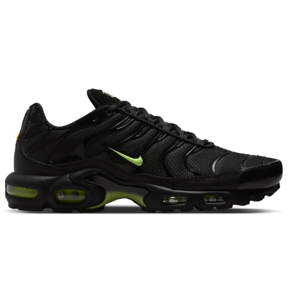 A side view of the Nike Air Max Plus TN Black Volt Neon trainer, showing the black mesh upper, bright Volt detailing, mini Nike Swoosh and sculpted Tuned Air sole.