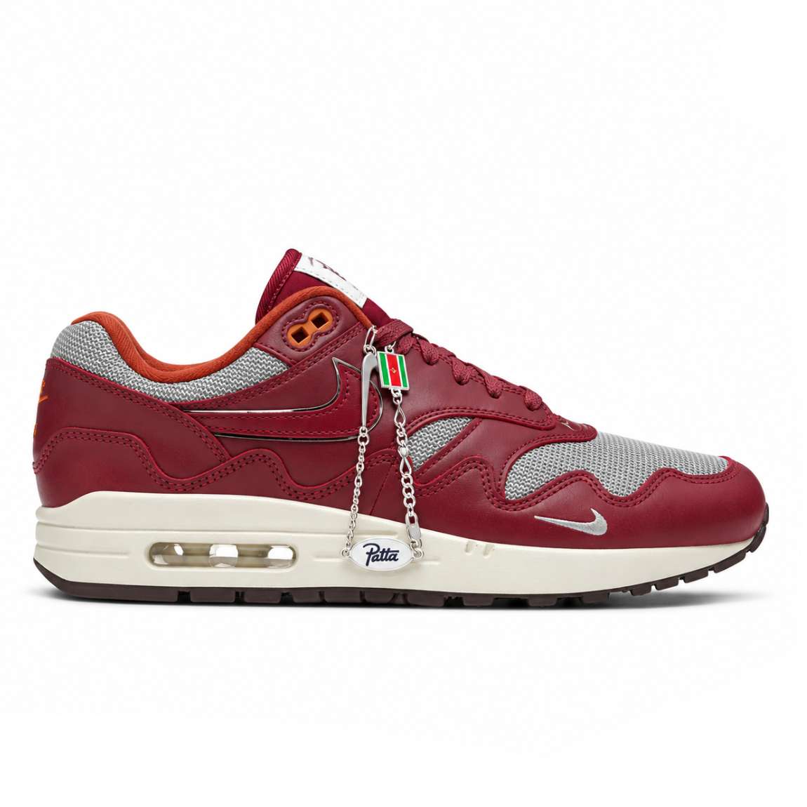 A side view of the Patta x Nike Air Max 1 Night Maroon showing the silver-grey mesh upper, maroon leather Swoosh and wave-shaped mudguard.