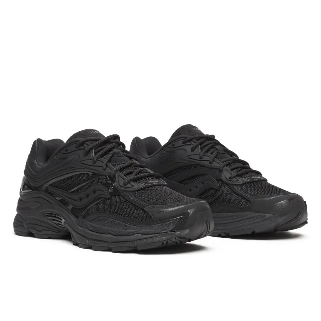 A pair of Saucony ProGrid Omni 9 Armour Black trainers featuring an all-black layered upper, tonal overlays, signature Saucony wave logos and chunky cushioned soles on a clean white background.