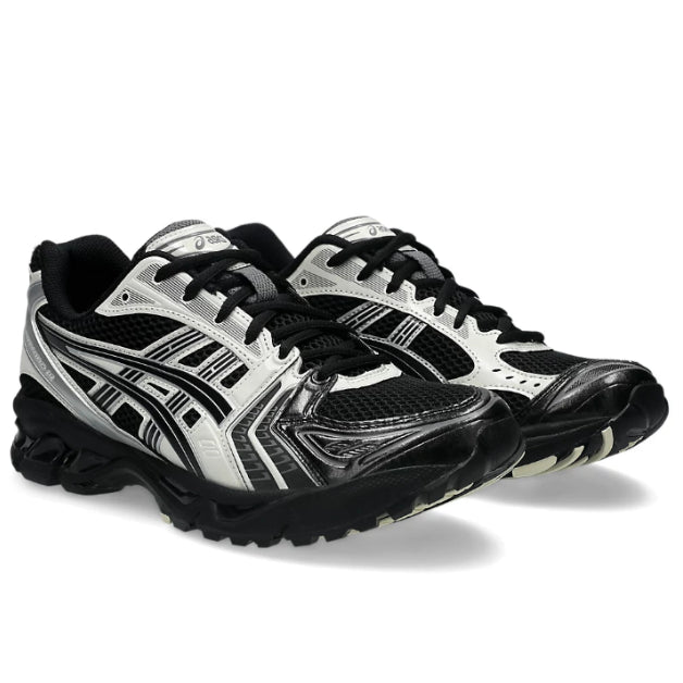 A pair of ASICS GEL-KAYANO 14 Black Cream trainers featuring a black and cream colourway, signature ASICS stripe detailing, layered technical panels and a cushioned GEL midsole on a clean white background.