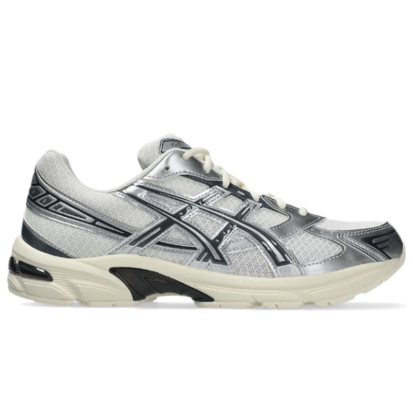 A side view of the ASICS GEL-1130 Cream Carrier Grey trainer, showing the cream mesh upper, Carrier Grey detailing, layered ASICS stripes and sculpted cushioned midsole.