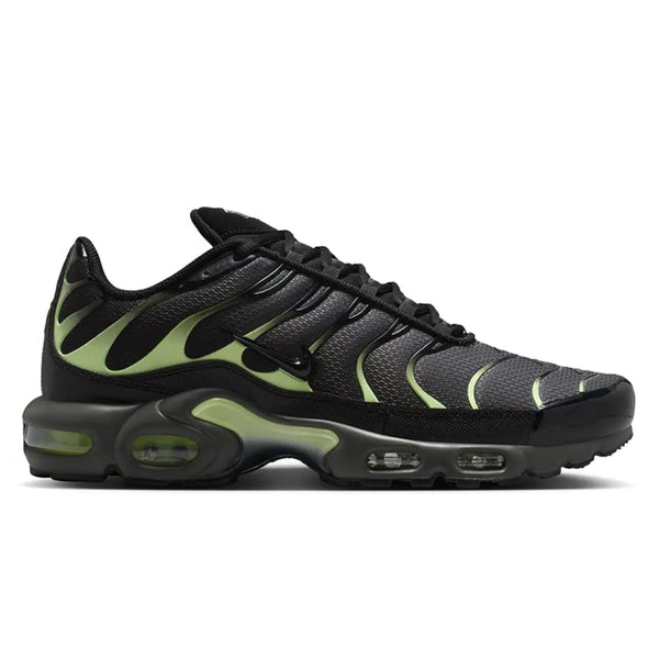 A side view of the Nike Air Max Plus TN Iron Grey Light Liquid Lime trainer, showing the Iron Grey upper, wavy TPU cage, Light Liquid Lime detailing and sculpted Tuned Air sole.