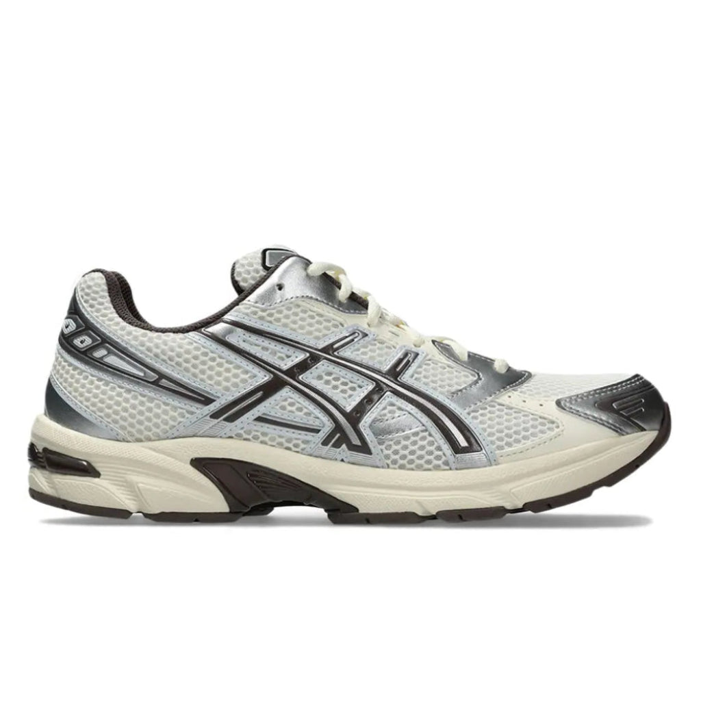 A side view of the ASICS GEL-1130 Cream Cocoa Powder trainer, showing the cream mesh upper, Cocoa Powder brown detailing, signature ASICS stripes and sculpted cushioned midsole.