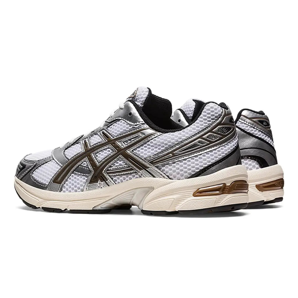 ASICS GEL-1130 White Clay Canyon 1201A256-113 front three-quarter pair view showing the white mesh toe box, metallic silver overlays, deep brown Clay Canyon tiger-stripe branding, white laces, and pre-aged sail foam midsole