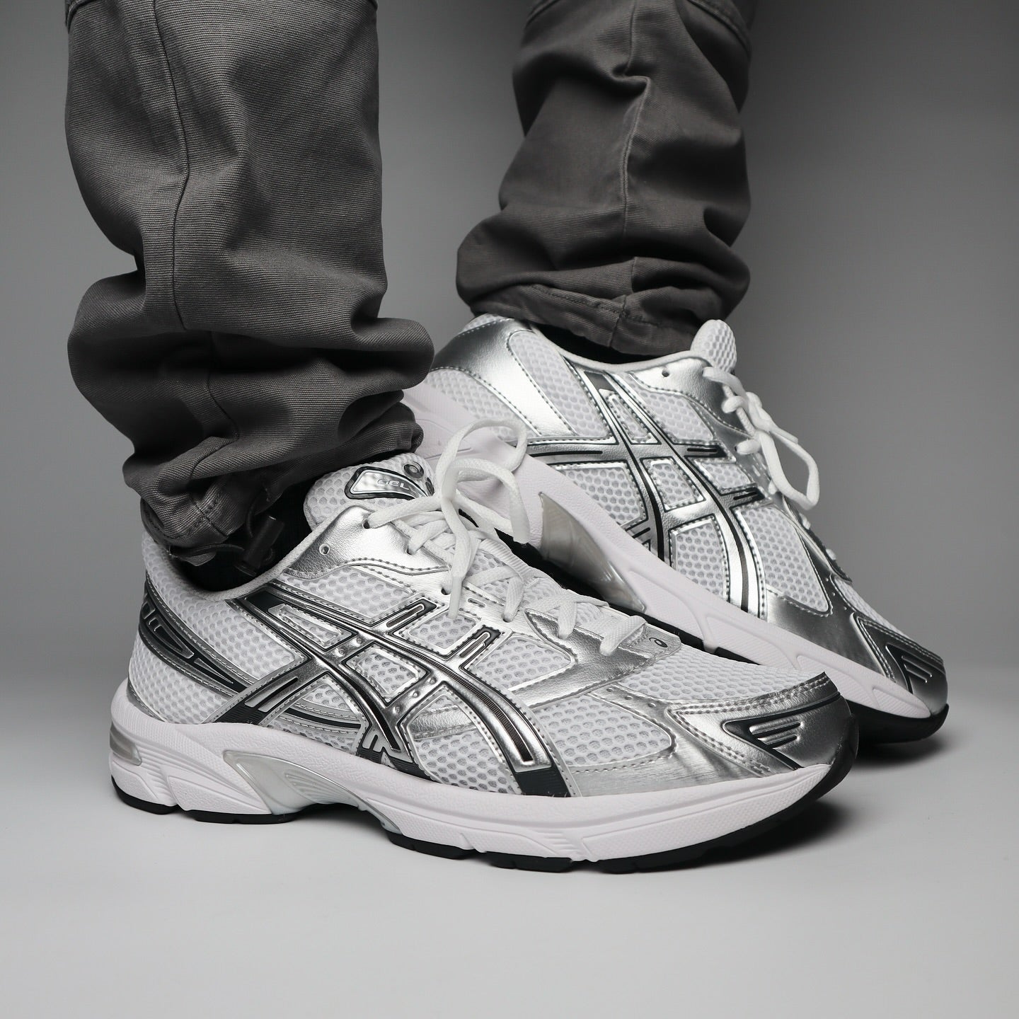 ASICS GEL-1130 White Silver on feet front view with silver and black accents