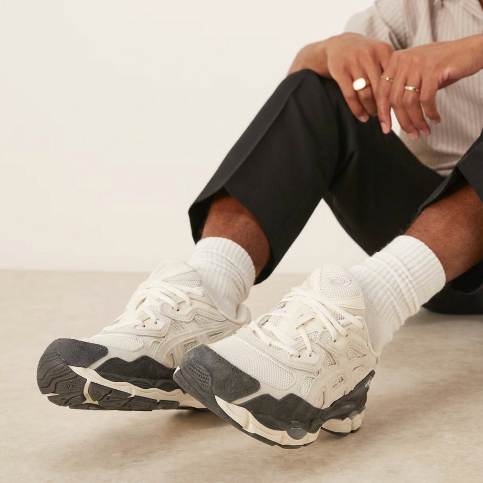 ASICS Gel-NYC Smoke Grey on feet seated view with black shorts and white socks