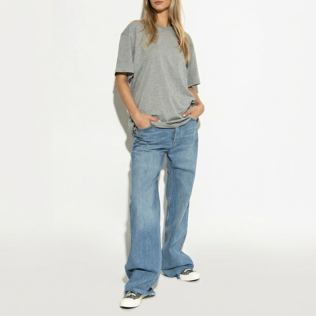 Comme des Garcons Play x Converse Chuck 70 Low Grey styled in full outfit with grey t-shirt and wide-leg light wash denim
