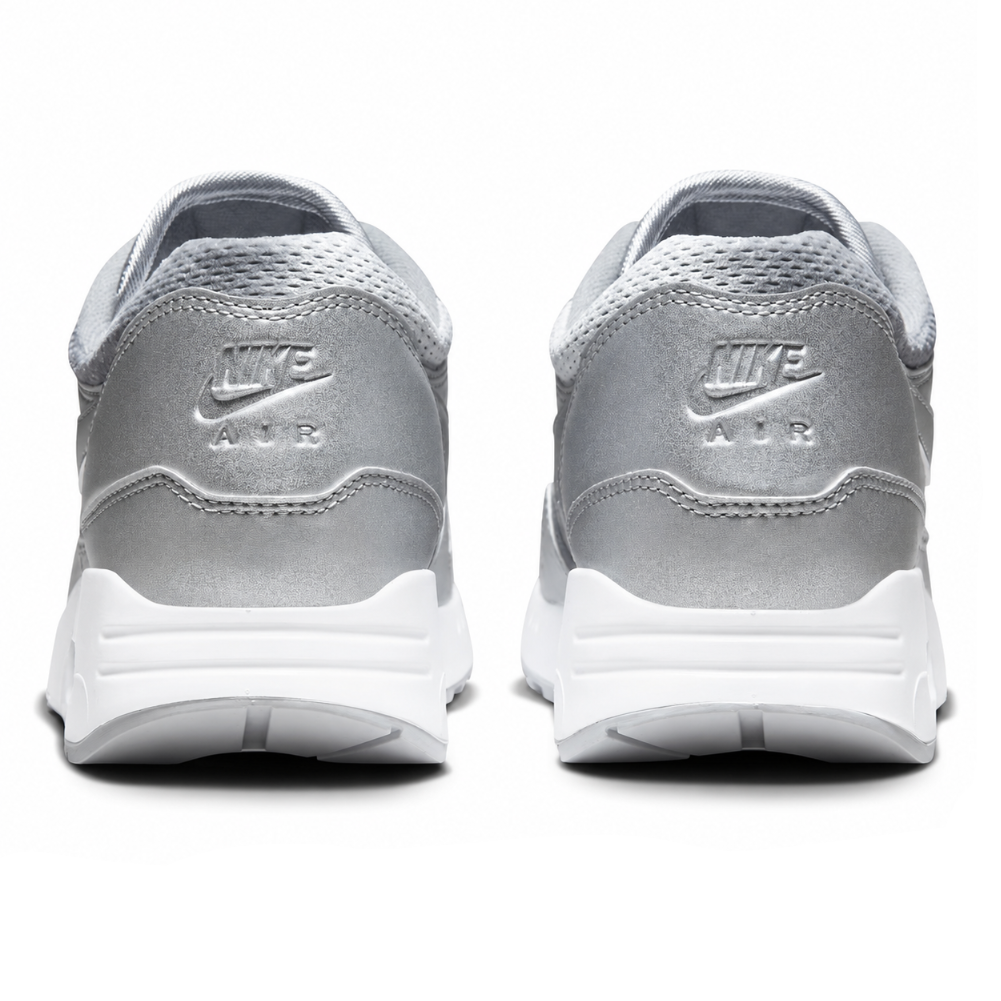 A pair of Nike Air sneakers shown from the back, featuring a metallic silver upper with a white sole on a clean white background.