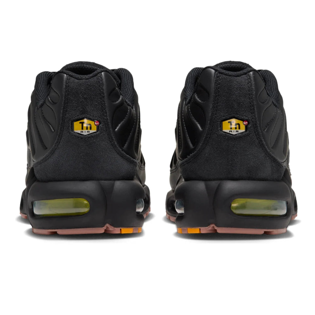 A rear view of the Nike Air Max Plus Premier Black Volt showing the black heel structure, TN branding and contrasting accent details.