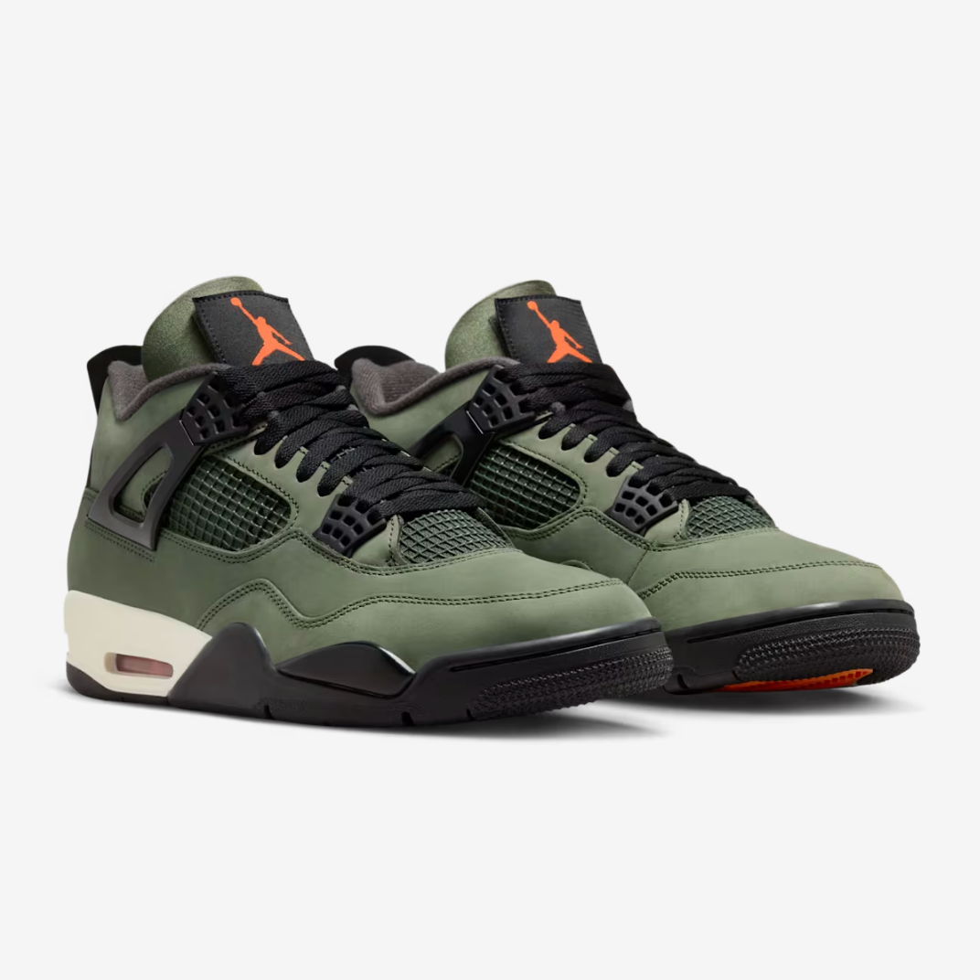 Jordan 4 Retro x UNDEFEATED - front three-quarter pair view showing olive nubuck upper, orange Jumpman tongue tab, black mesh netting, sail midsole and orange rubber outsole accent