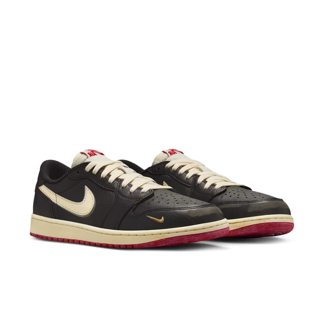 Nigel Sylvester x Jordan 1 Low OG Better With Time front pair view showing black tumbled leather, muslin Swoosh, Bike Air tongue tags in red, cream laces, and varsity red outsole