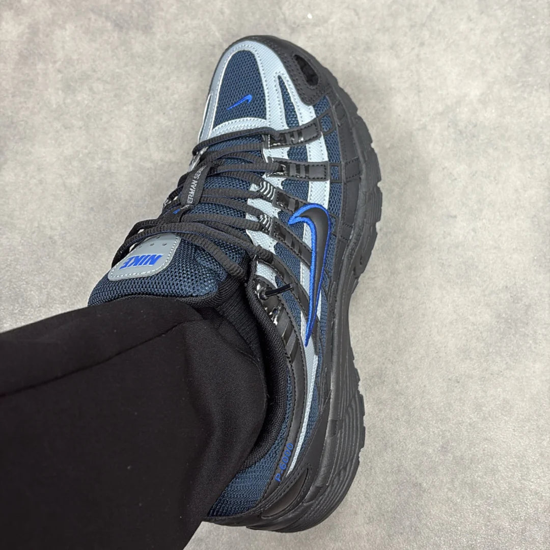 Nike P-6000 Black Obsidian on foot top-down view showing blue Nike tongue branding and Bowerman Series text