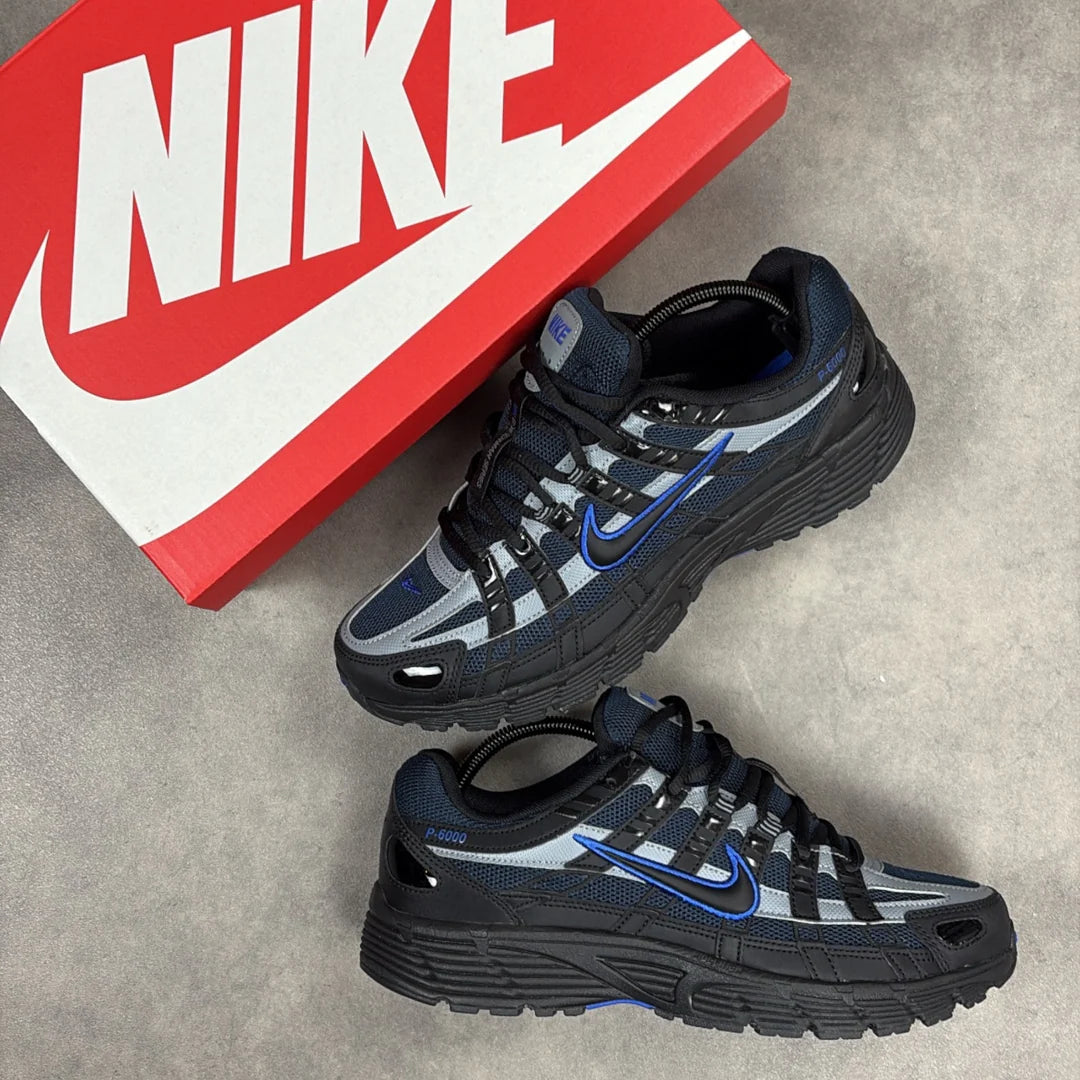 Nike P-6000 Black Obsidian pair displayed with red Nike box showing blue Swoosh and grey reflective overlays