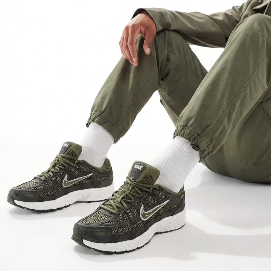 Nike P-6000 Sequoia Medium Olive on feet seated view with cargo pants showing medial and lateral sides