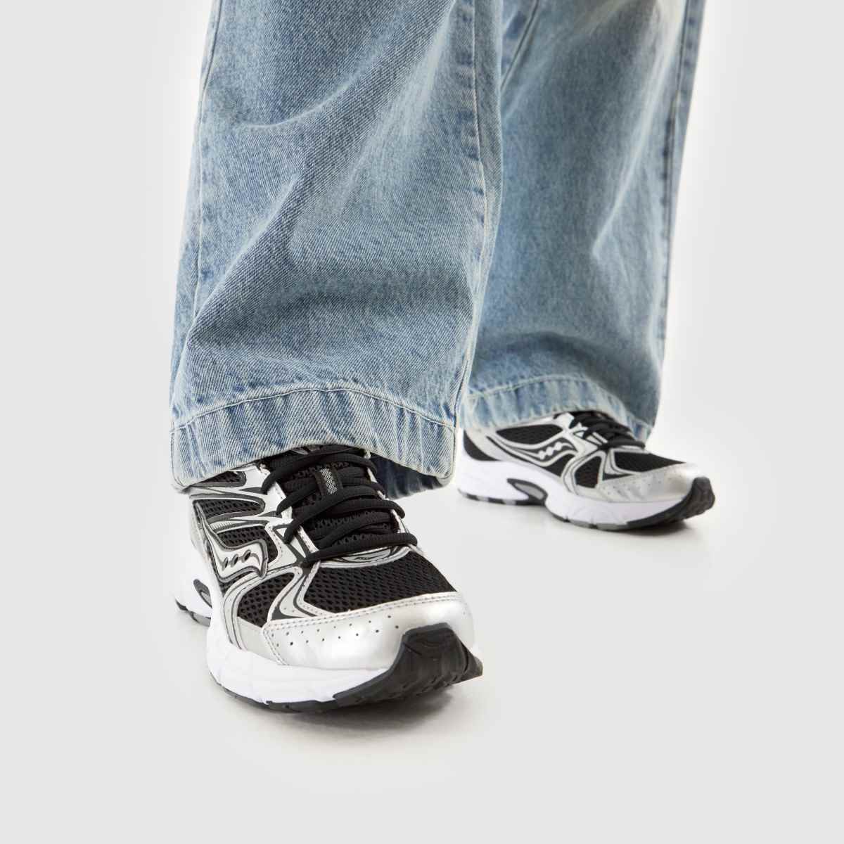 Saucony Grid Ride Millennium Black Silver pair displayed on black marble slab showing lateral profile and outsole tread with Grid cushioning technology