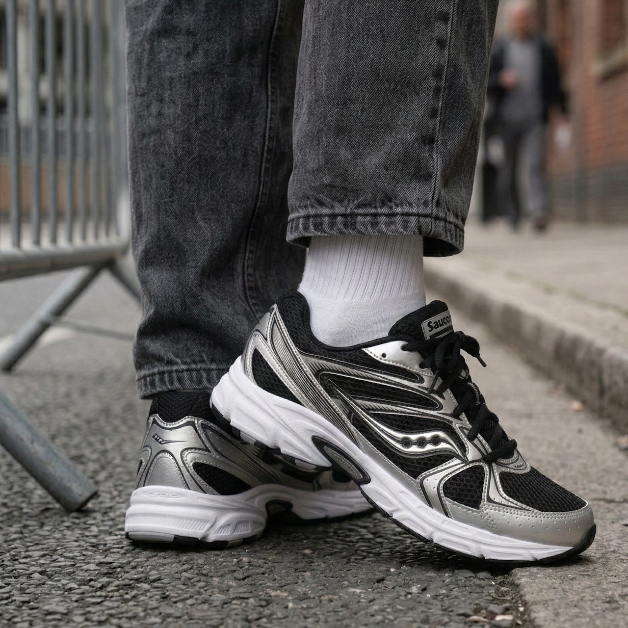 Saucony Grid Ride Millennium Black Silver pair displayed with Saucony branded box one shoe on top one in front showing full lateral profile on white background