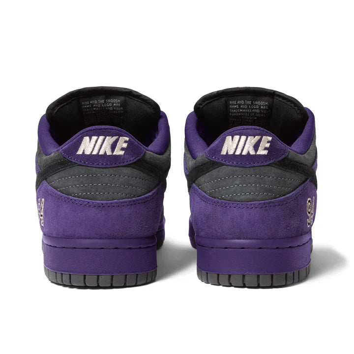Supreme x Nike SB Dunk Low Ink Black pair rear view showing Nike heel branding on purple and dark grey suede