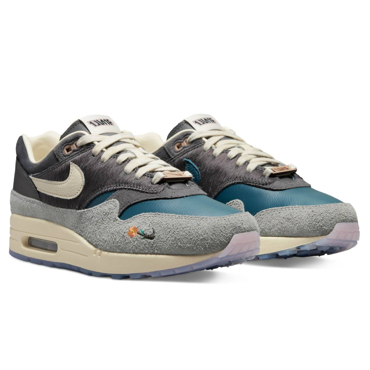 A pair of Kasina x Nike Air Max 1 Wong-Ang Grey trainers featuring deep teal leather, grey suede mudguards, dark faux horsehair overlays and Sail midsoles on a clean white background.