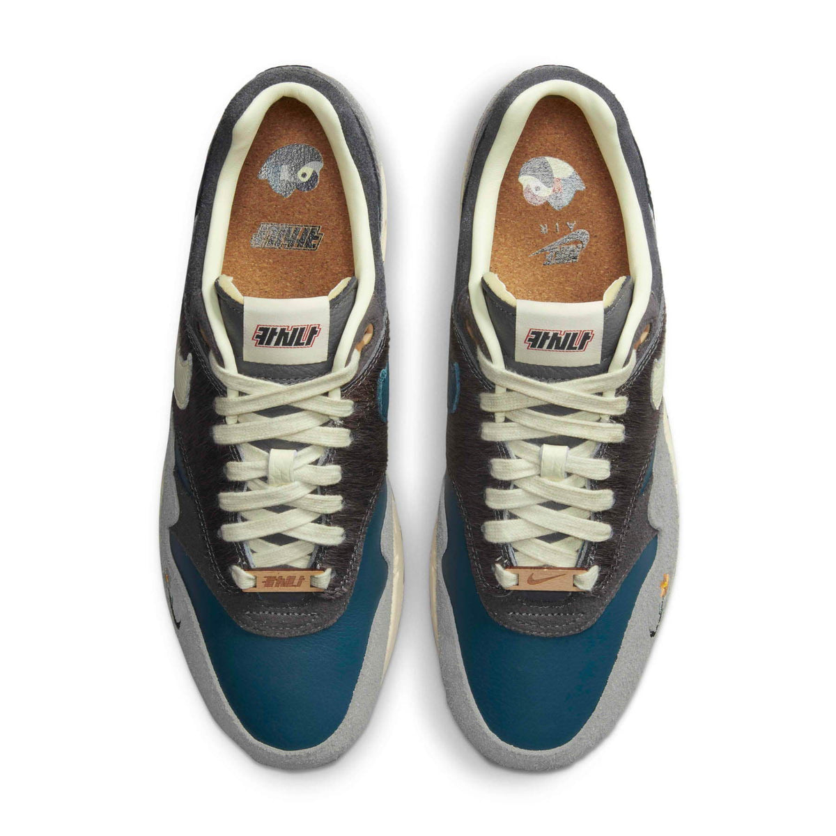 An angled view of the Kasina x Nike Air Max 1 Wong-Ang Grey trainers, highlighting the tumbled leather, faux horsehair eyestays, suede detailing and wooden lace deubrés.