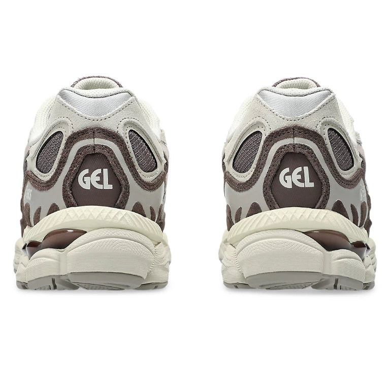 A rear view of the ASICS GEL-NYC Cocoa Powder Pure Silver trainers, showing the structured heel, warm cocoa colouring, silver accents and cushioned sole on a clean white background.