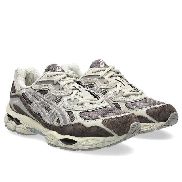 A pair of ASICS GEL-NYC Cocoa Powder Pure Silver trainers featuring warm brown mesh, suede overlays, metallic silver detailing, signature ASICS stripes and a sculpted cushioned sole on a clean white background.