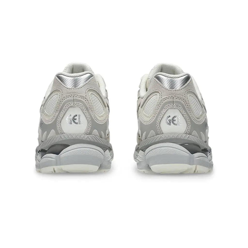 A rear view of the ASICS GEL-NYC Cream Grey trainers, showing the structured heel, layered neutral detailing and sculpted cushioned sole on a clean white background.